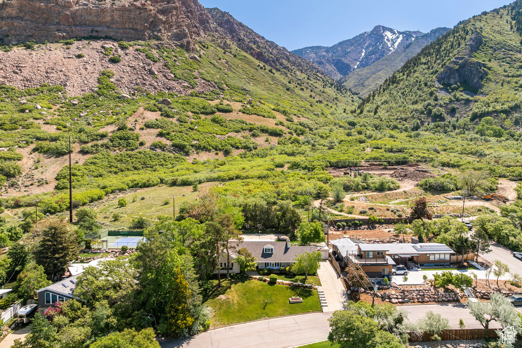 Aerial view of property and surrounding area with a mountainous background