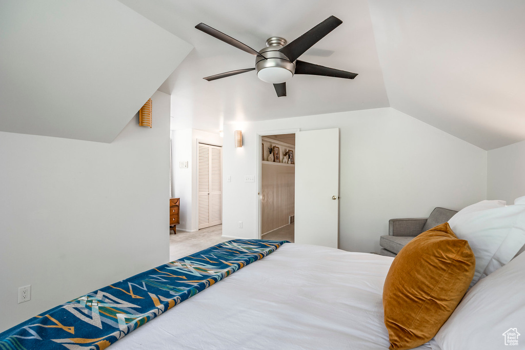 Bedroom featuring vaulted ceiling, carpet floors, ceiling fan, and a closet