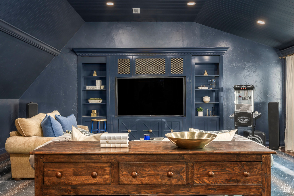 Living area with lofted ceiling, built in shelves, carpet floors, and recessed lighting
