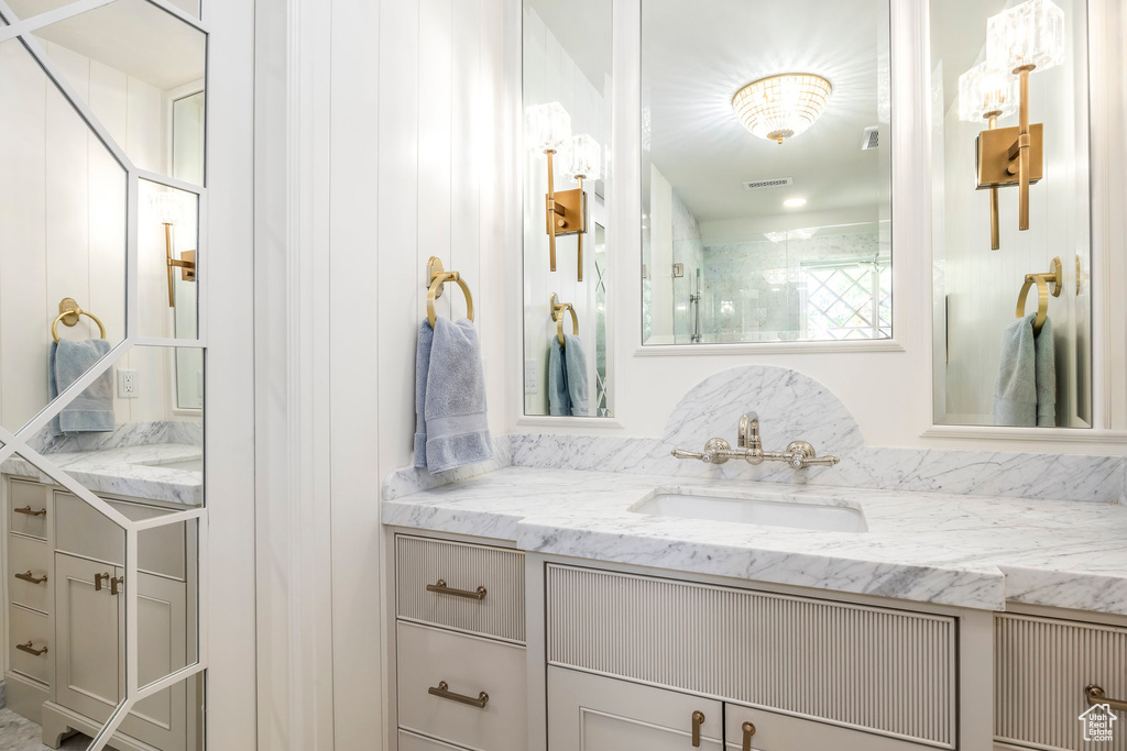 Bathroom featuring vanity and a walk in shower