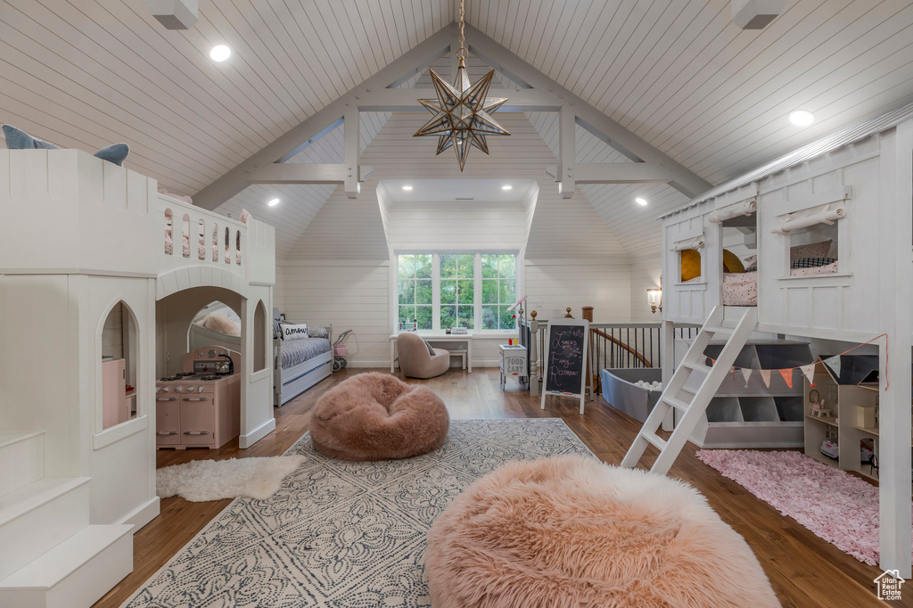 Bedroom with lofted ceiling, wood finished floors, a chandelier, and recessed lighting