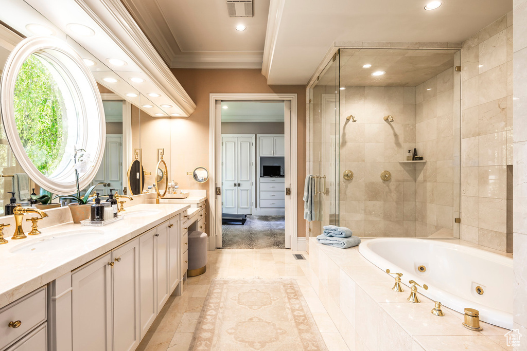 Bathroom featuring a stall shower, ornamental molding, recessed lighting, a tub with jets, and double vanity