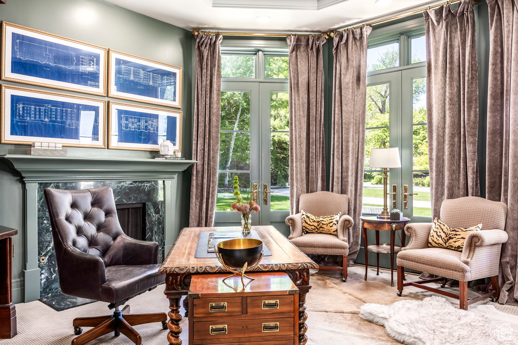Sitting room with french doors, carpet, and a fireplace