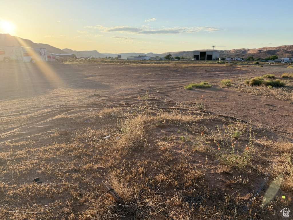 View of yard featuring a mountain view, a rural view, and an outbuilding