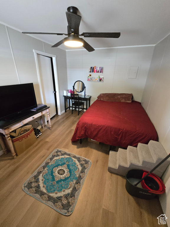Bedroom featuring wood finished floors and ceiling fan