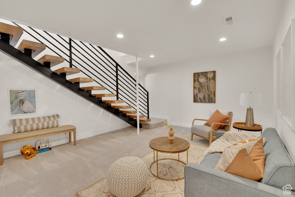 Carpeted living area featuring stairway, recessed lighting, and baseboards