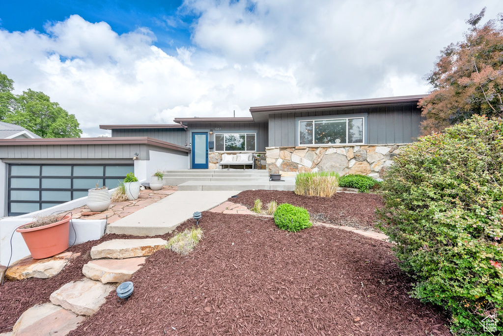View of front of house with stone siding