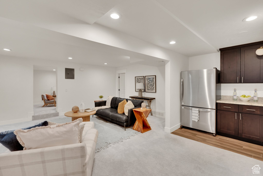 Living room with recessed lighting, baseboards, and light wood-style floors