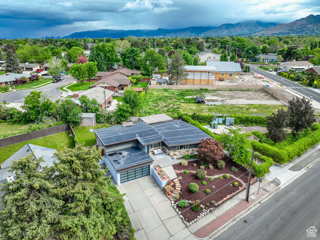 Aerial view of residential area featuring a mountainous background