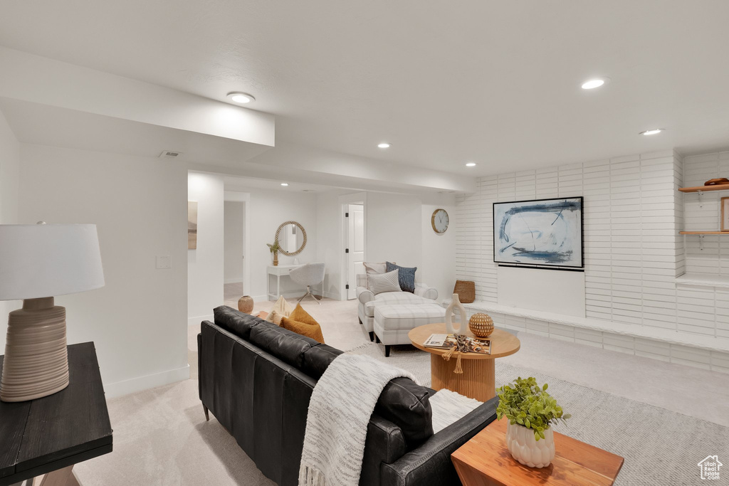 Living area featuring light colored carpet, recessed lighting, and baseboards