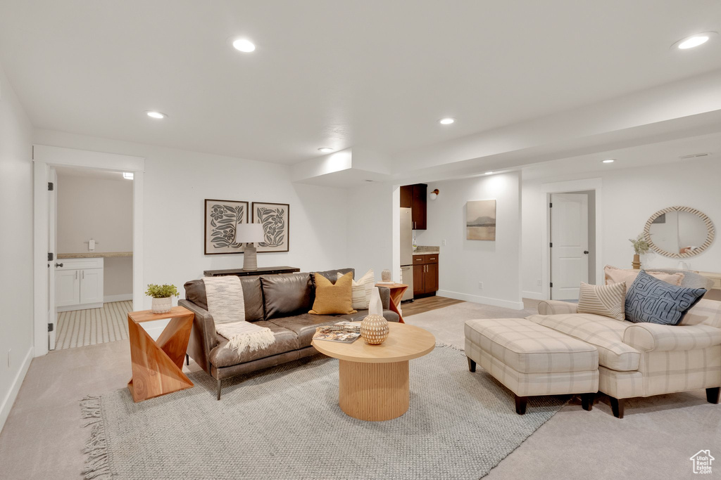 Living area featuring recessed lighting, light carpet, and baseboards