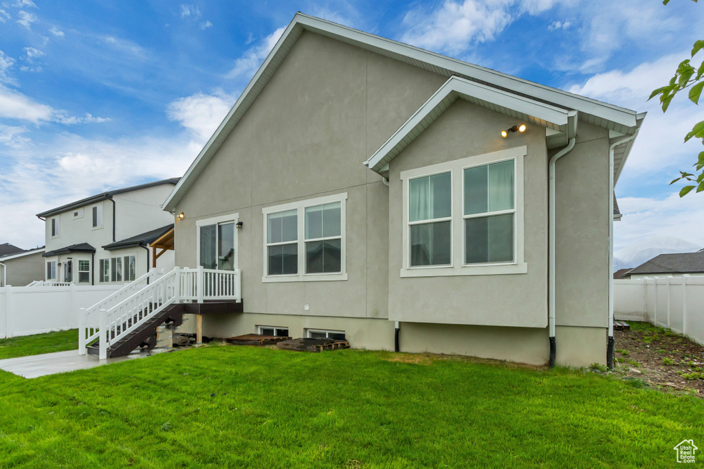 Back of property featuring stucco siding