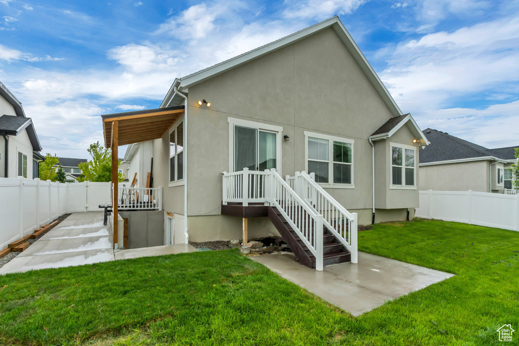 Rear view of property featuring a patio and stucco siding