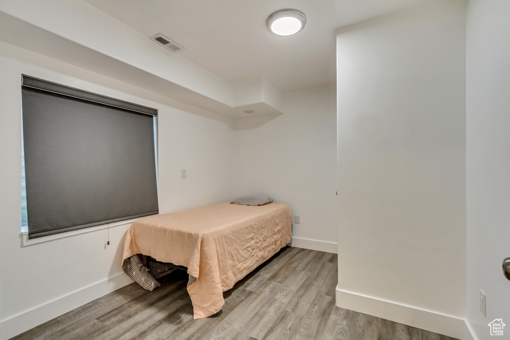 Bedroom featuring light wood finished floors and baseboards
