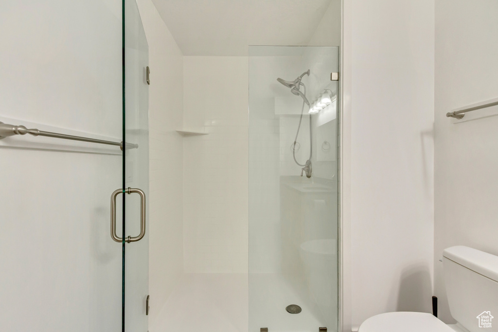 Full bathroom featuring toilet and a stall shower