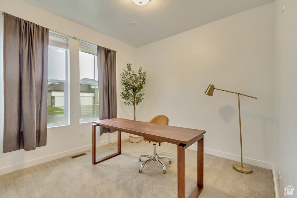 Office area featuring baseboards and light colored carpet