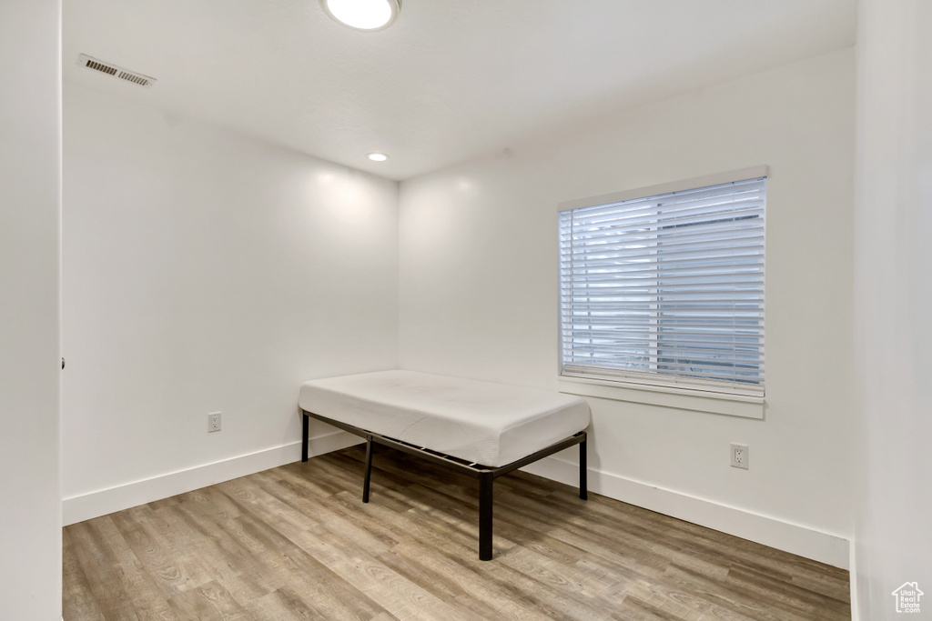 Unfurnished room with wood finished floors and baseboards
