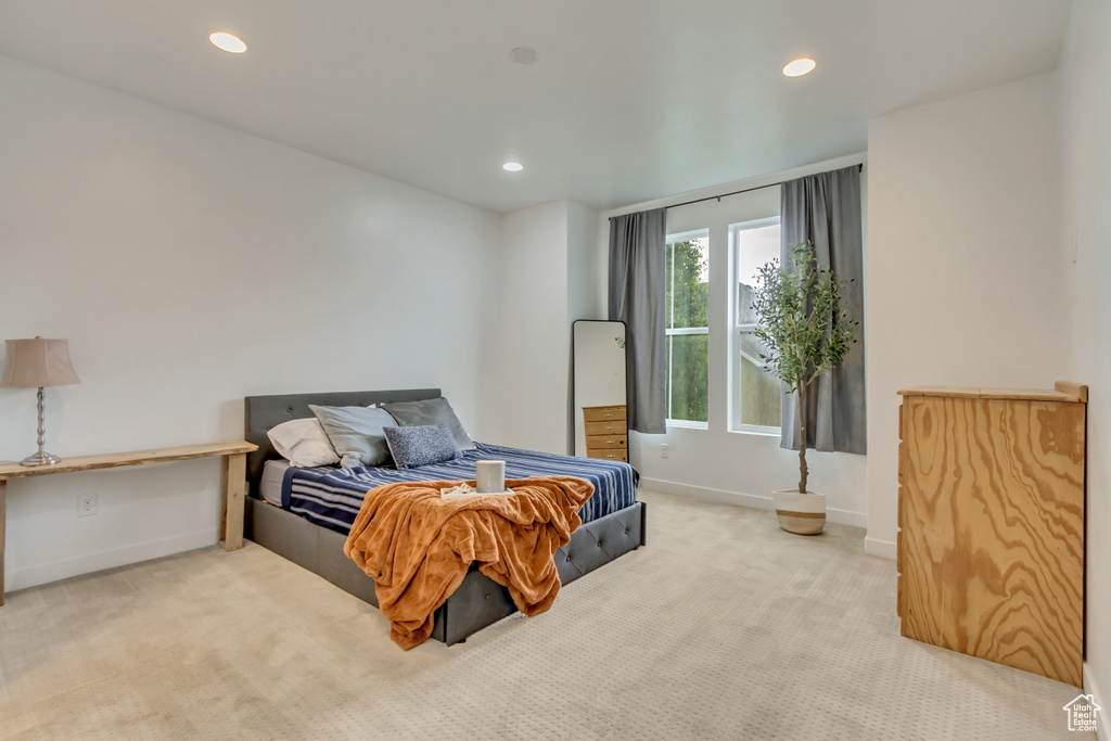 Carpeted bedroom with recessed lighting and baseboards