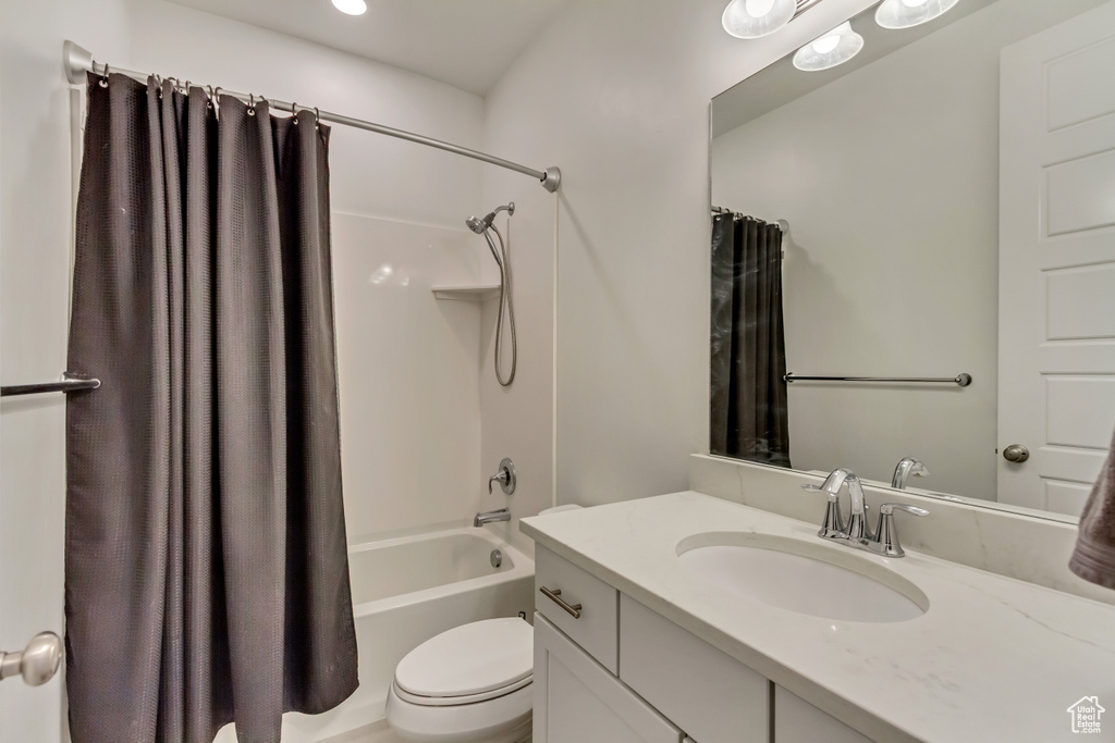 Full bath with vanity, toilet, and shower / tub combo