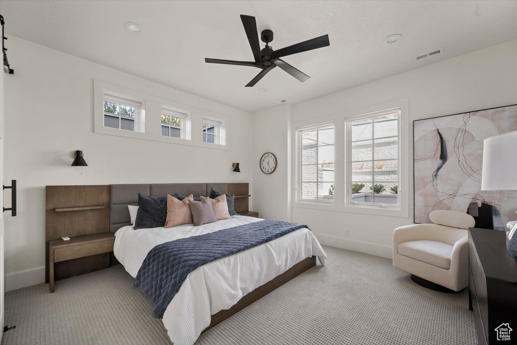 Carpeted bedroom with baseboards, ceiling fan, and recessed lighting