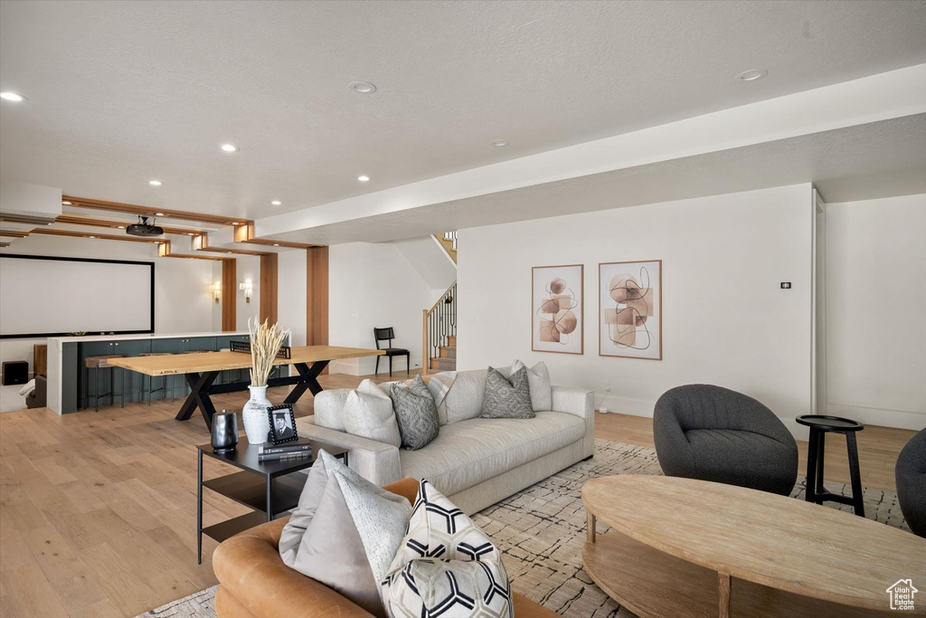 Living area featuring stairway, light wood-style floors, recessed lighting, and baseboards