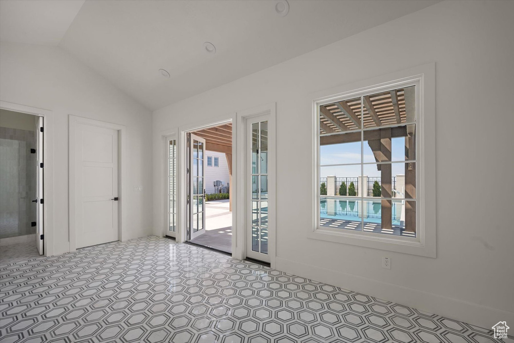 Unfurnished room with vaulted ceiling