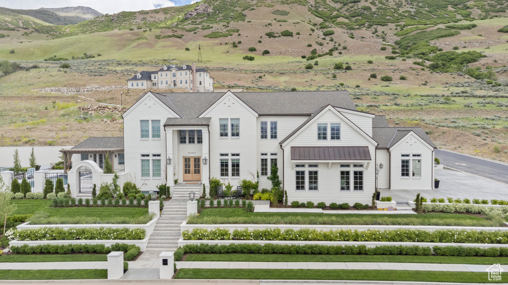 View of front of house with a standing seam roof, a mountain view, and metal roof