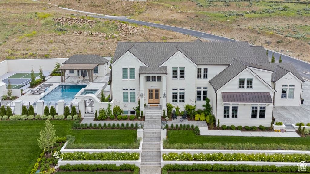 View of subject property featuring a pool
