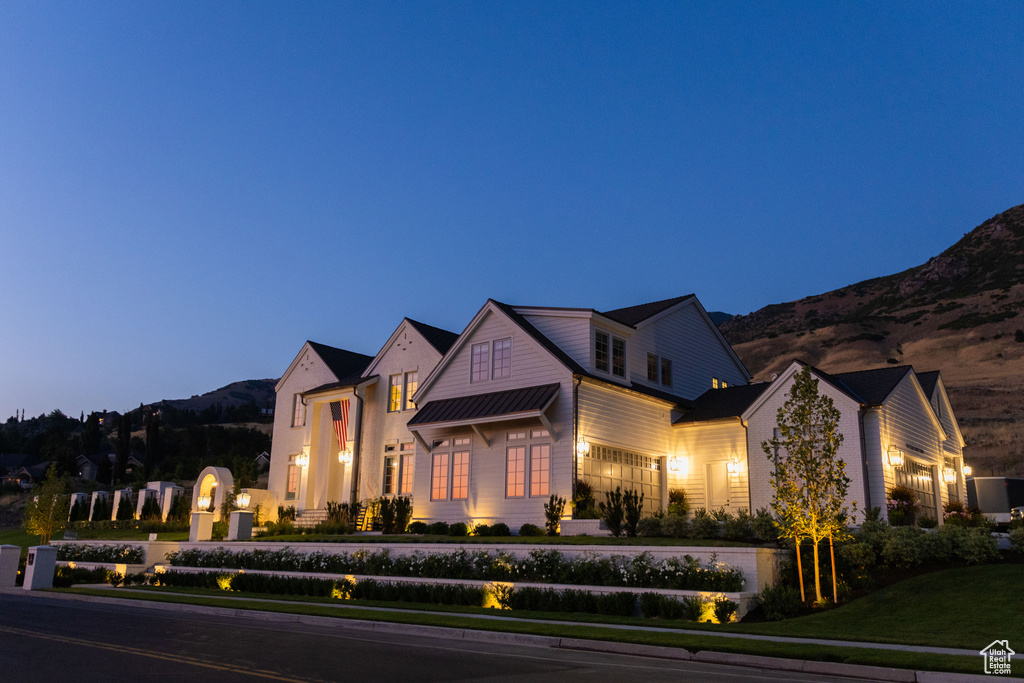 View of front of house featuring a mountain view and a front lawn