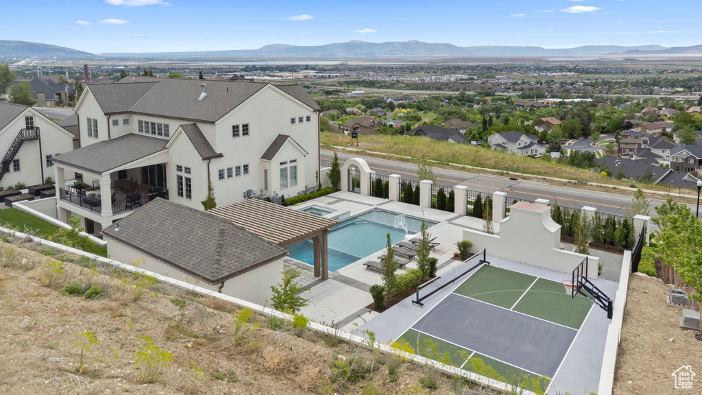 Aerial view of residential area with a pool and mountains