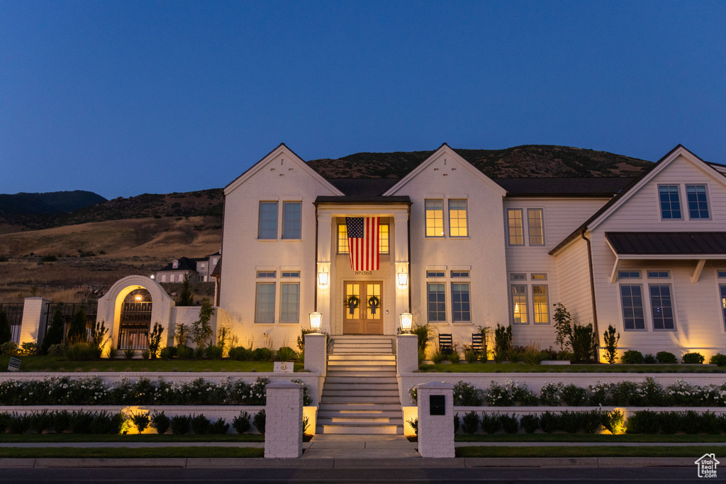 View of front of house featuring a mountain view and french doors