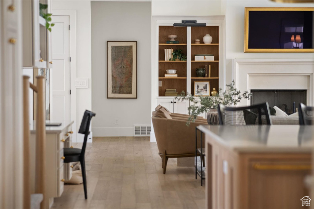 Living room with baseboards, wood finished floors, and a fireplace