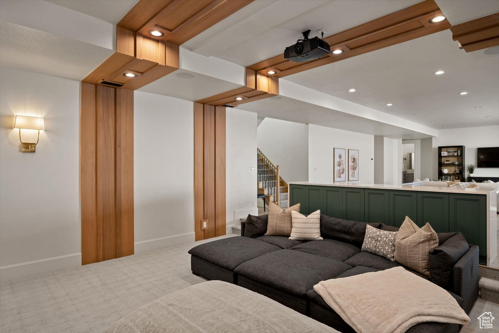 Living area with light colored carpet, baseboards, recessed lighting, and stairway