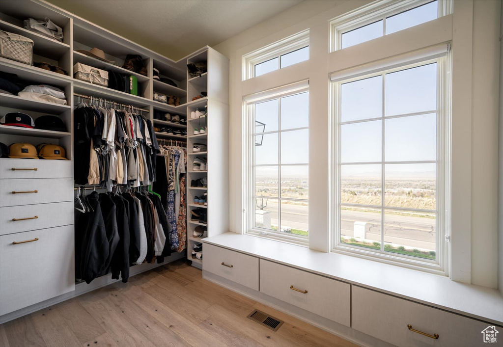 Spacious closet with light wood finished floors
