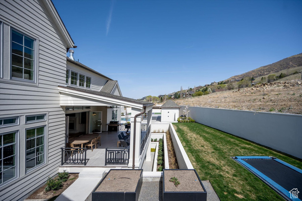 View of yard featuring a mountain view and a patio
