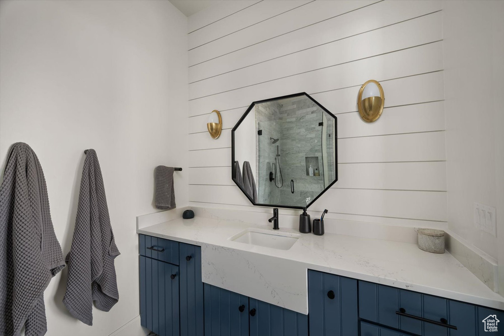 Full bath featuring a stall shower and vanity