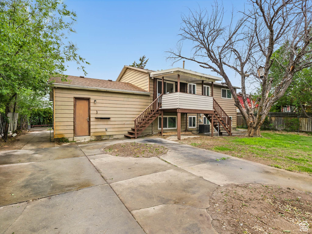 Back of property with stairway and cooling unit