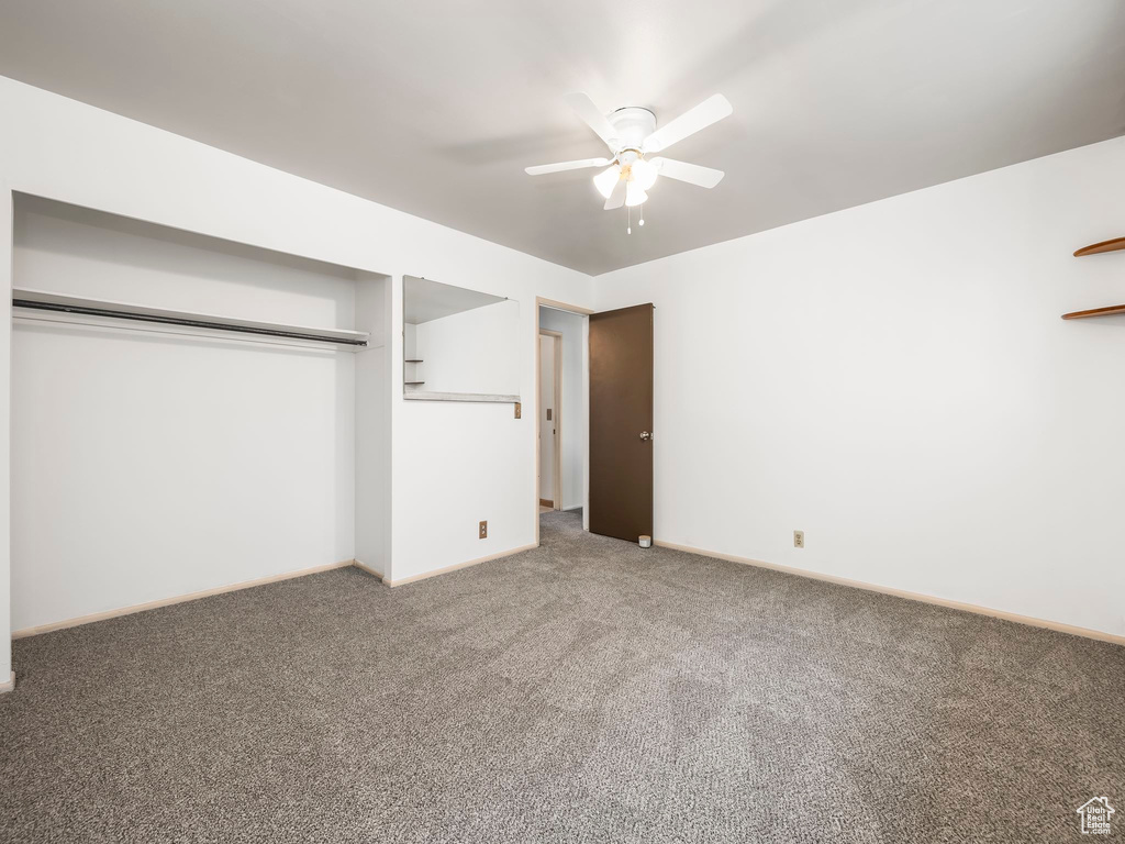 Unfurnished bedroom featuring light carpet, a closet, and baseboards