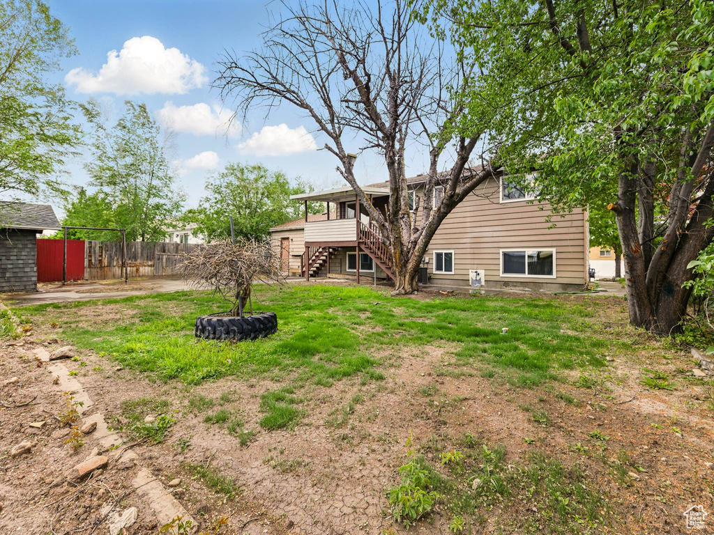 View of yard featuring stairs and a deck