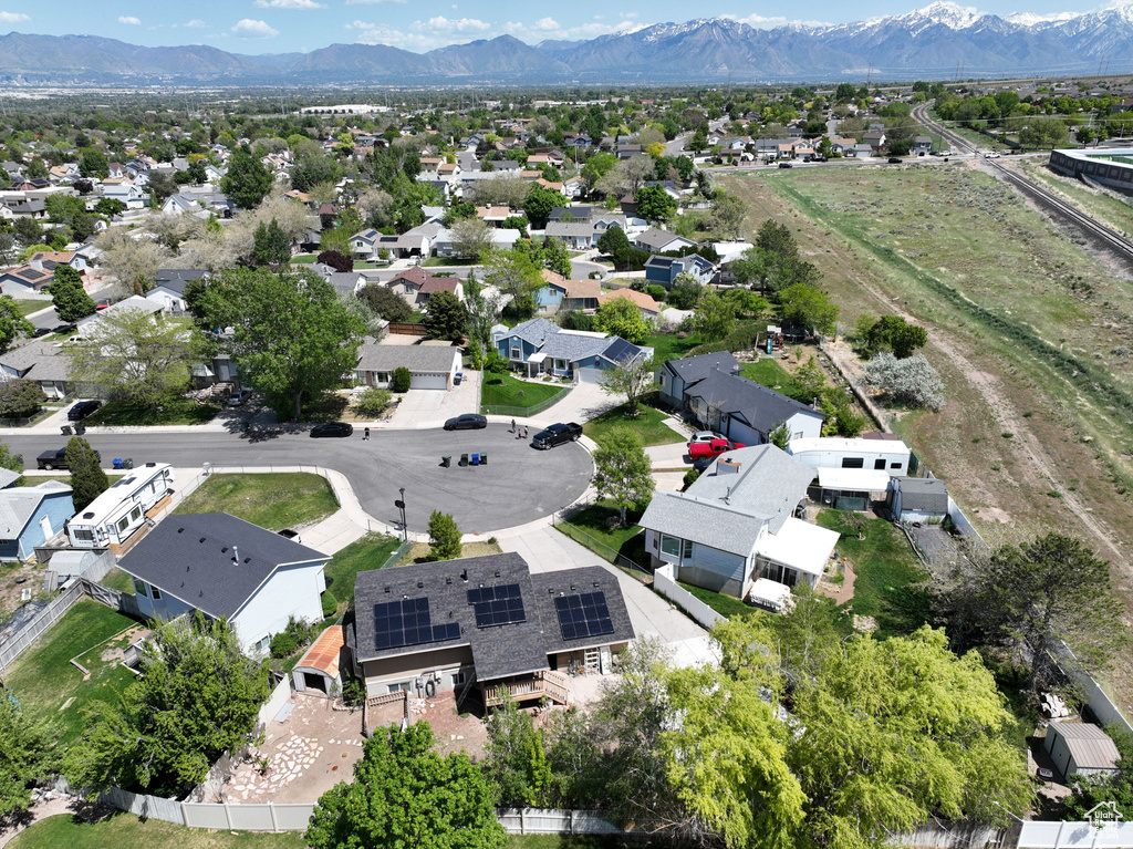 Aerial view of property's location with mountains and nearby suburban area