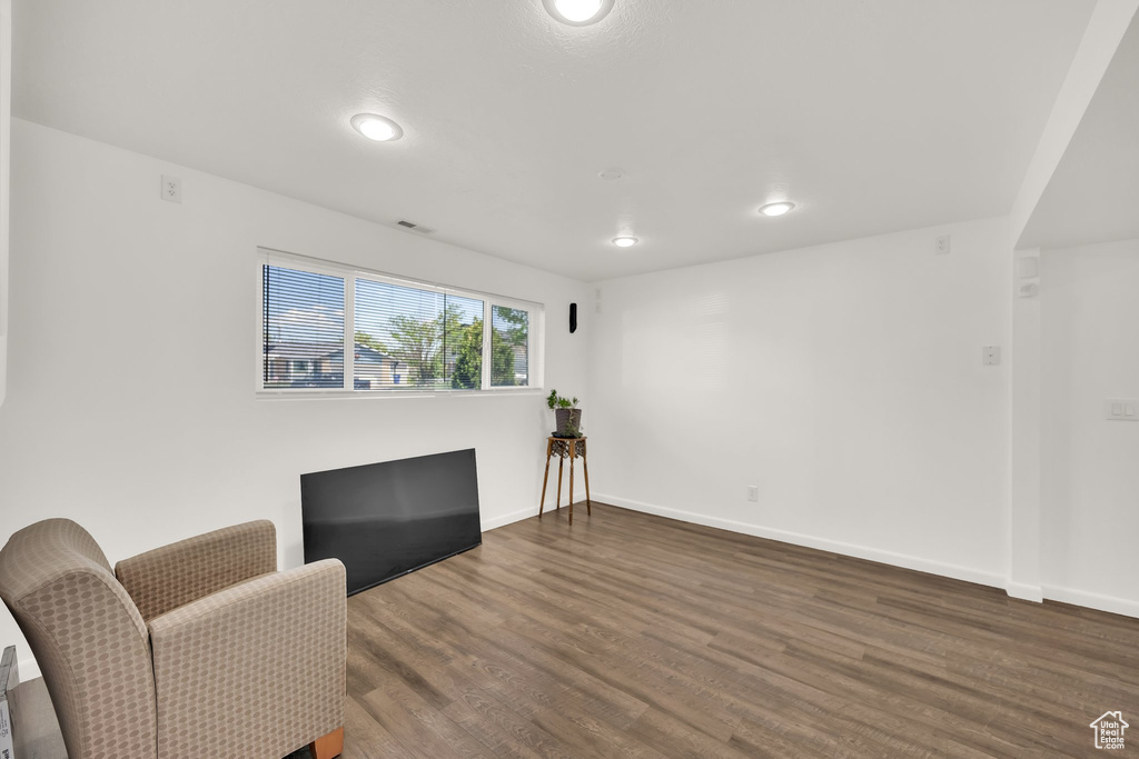 Sitting room with recessed lighting, dark wood-type flooring, and baseboards