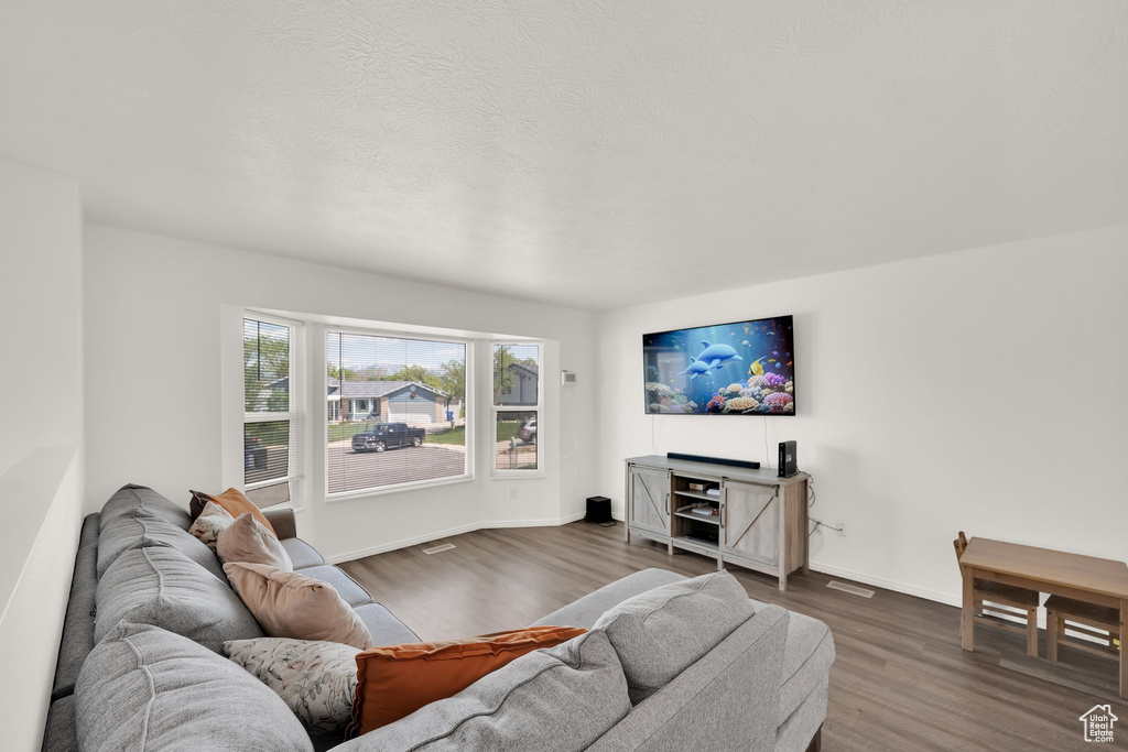 Living area with dark wood finished floors and baseboards