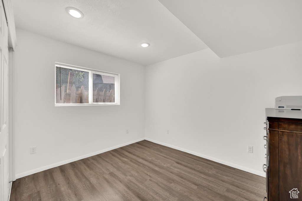 Unfurnished bedroom featuring wood finished floors, baseboards, and recessed lighting