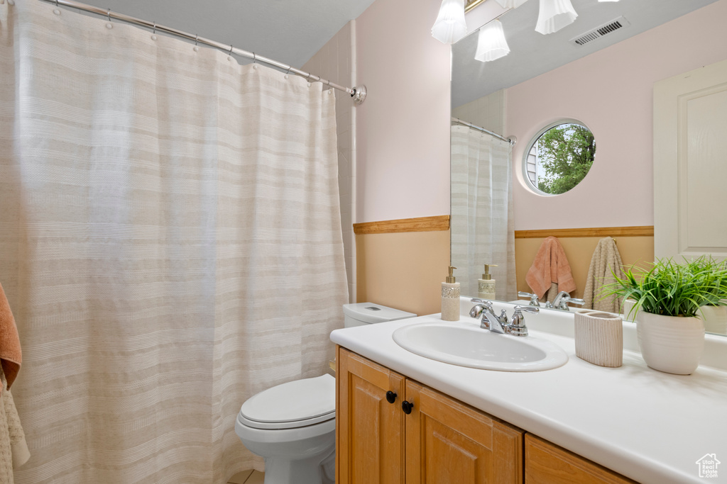 Full bathroom with toilet and vanity