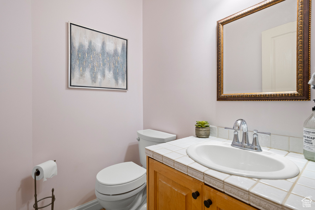 Half bathroom featuring toilet and vanity