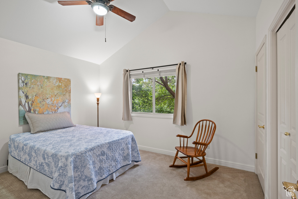 Bedroom featuring vaulted ceiling, carpet, baseboards, and ceiling fan