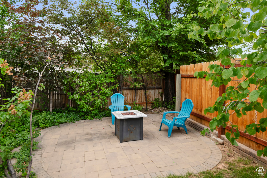 View of patio / terrace featuring an outdoor fire pit and a fenced backyard