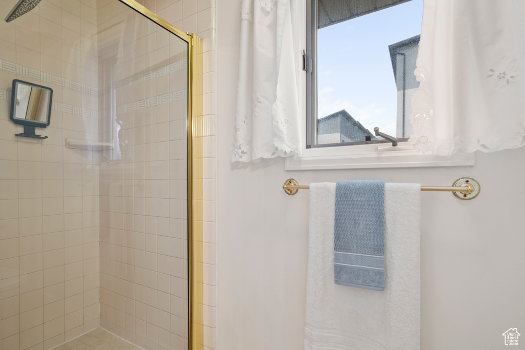 Full bath featuring tiled shower