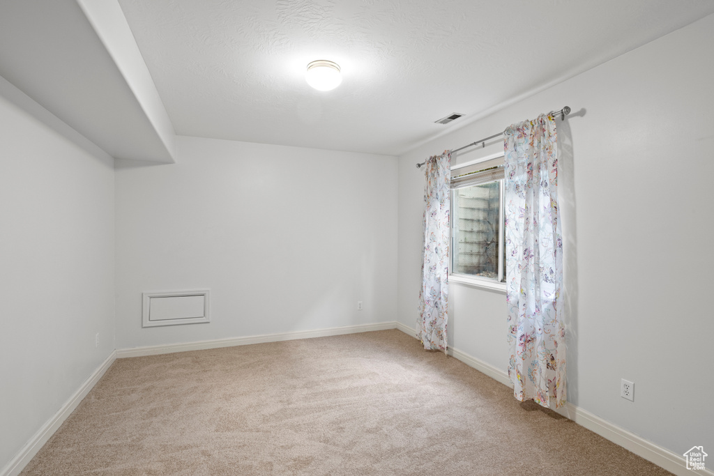 Spare room with carpet floors and baseboards