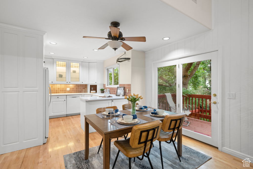 Dining space featuring light wood-style floors, ceiling fan, and recessed lighting